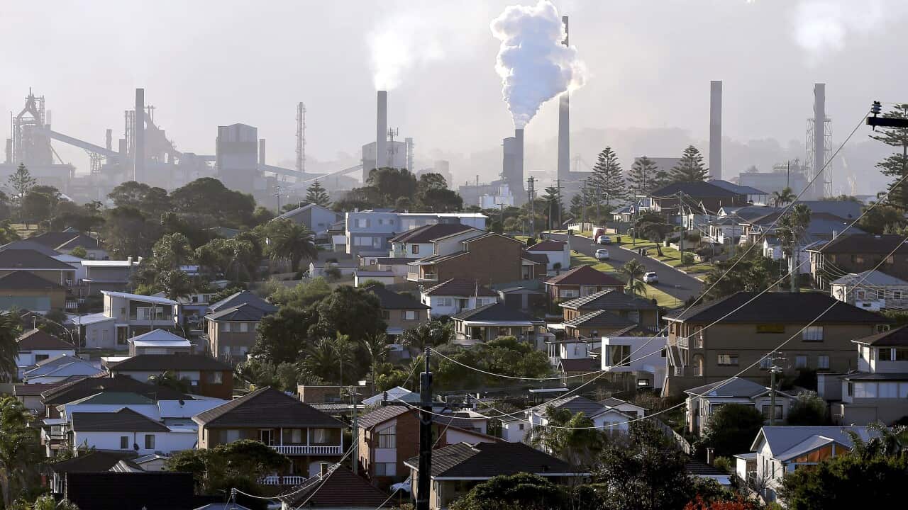 Smoke billows out of a chimney stack of steel works factories in Port Kembla, south of Sydney.  