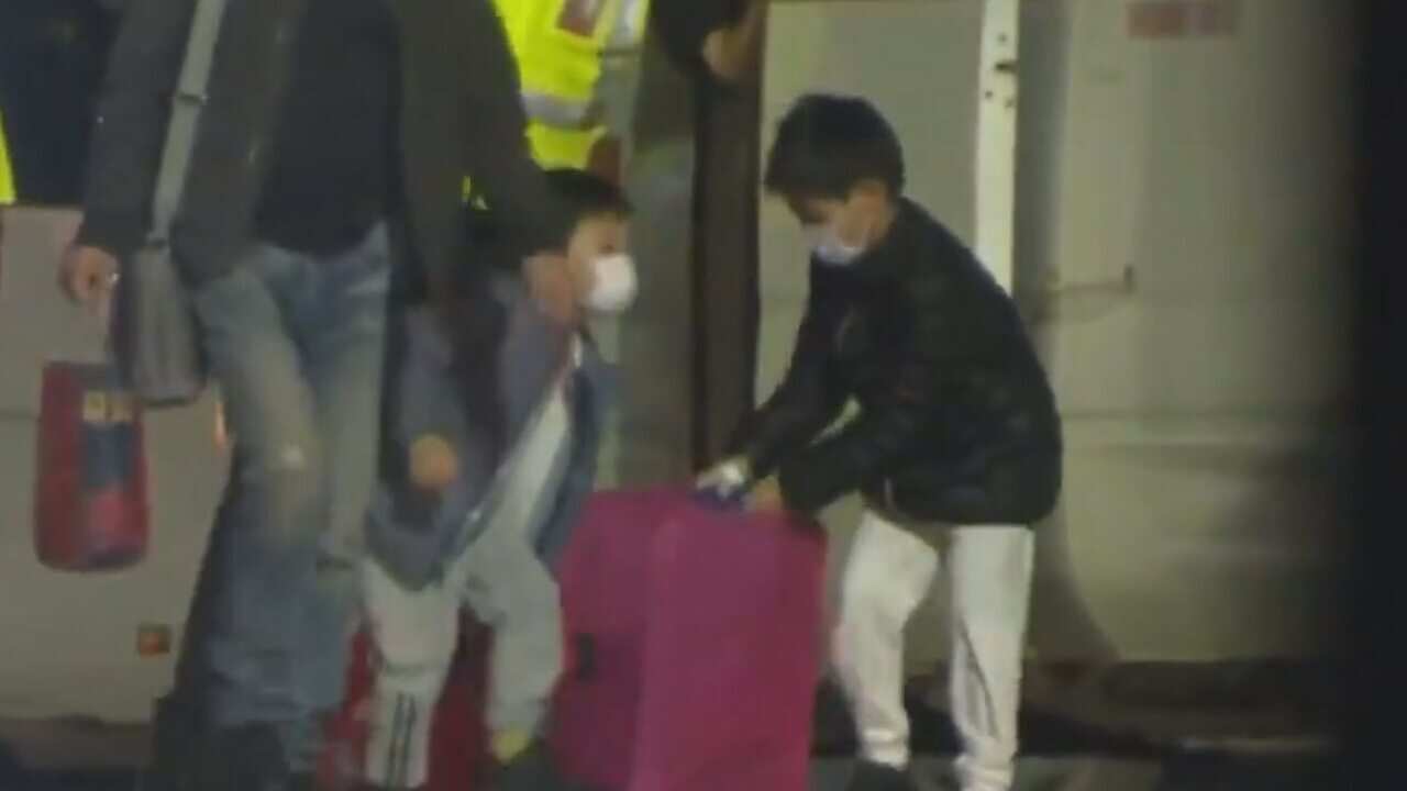 Children evacuated from Wuhan seen arriving at Christmas Island on Tuesday.