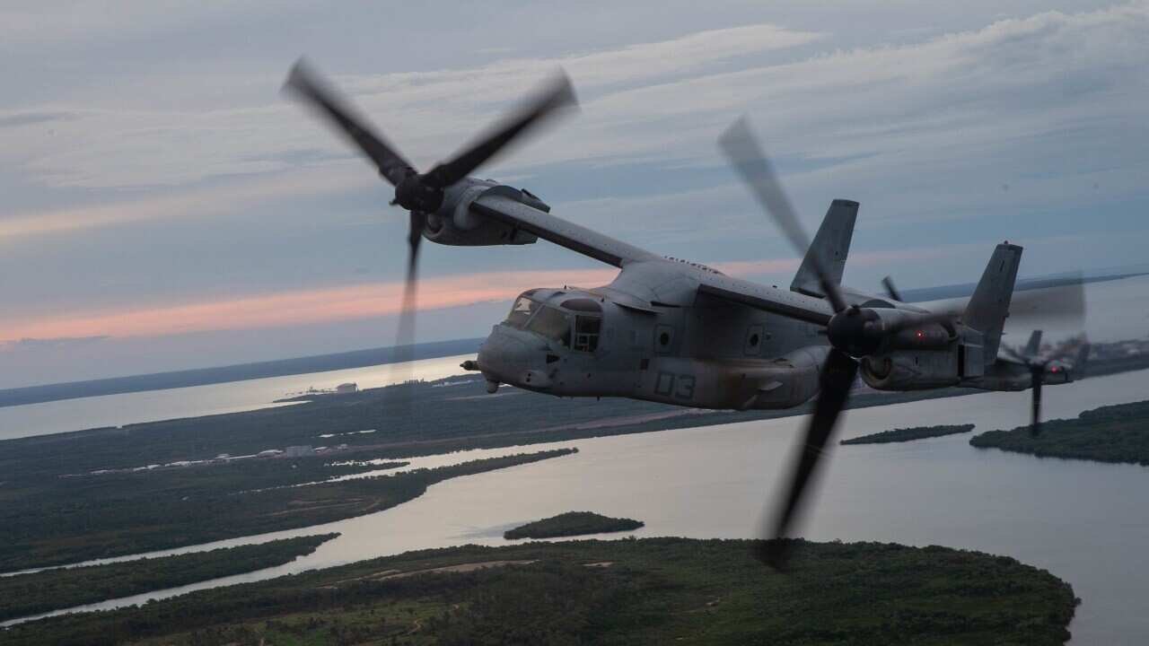 A military airplane flies over Darwin.