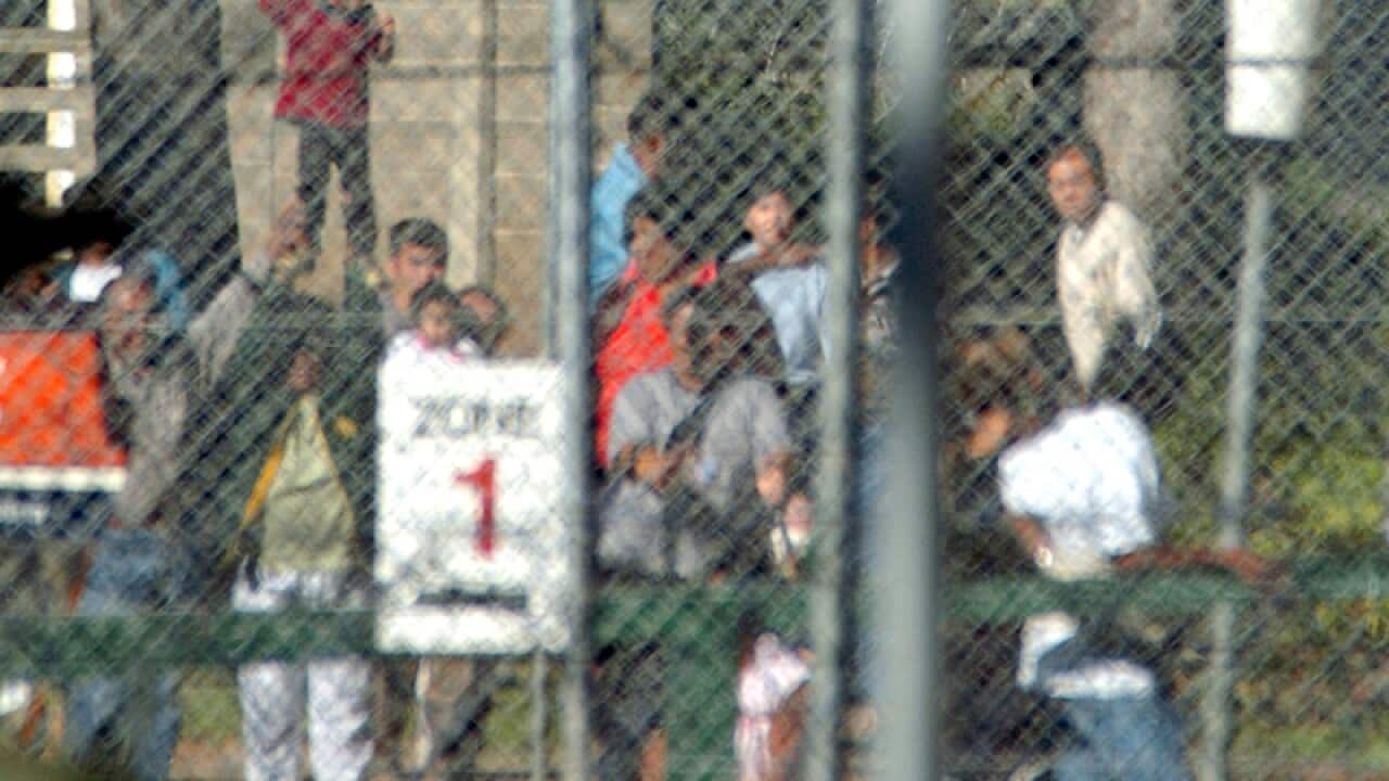 A child behind the fences of the Villawood Detention Centre