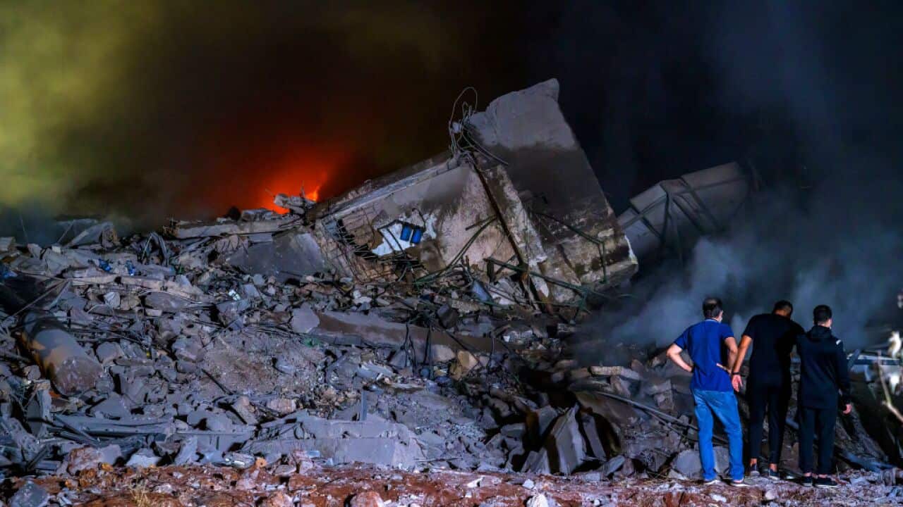 Rescue workers gather at the site of air strikes in Beirut.