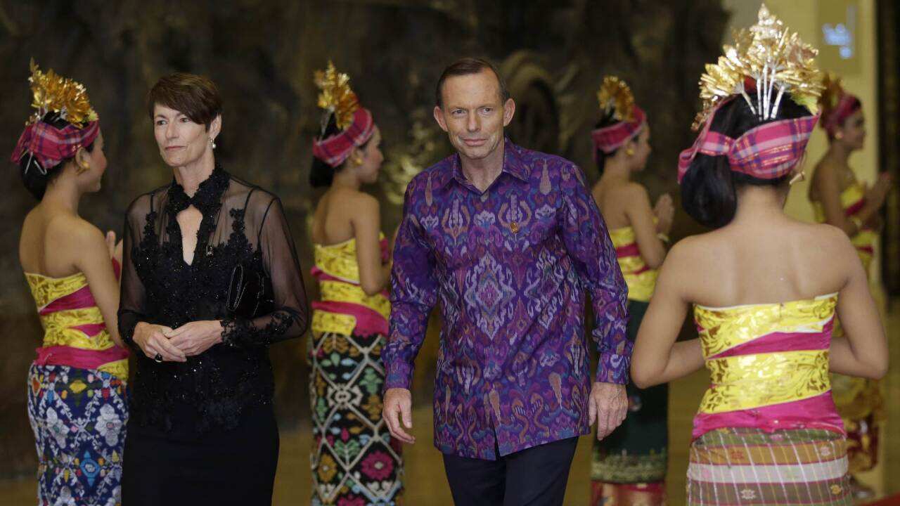 Tony Abbott wearing a traditional Balinese woven fabric, arrives with his wife Margie for a gala APEC dinner - AAP.jpg