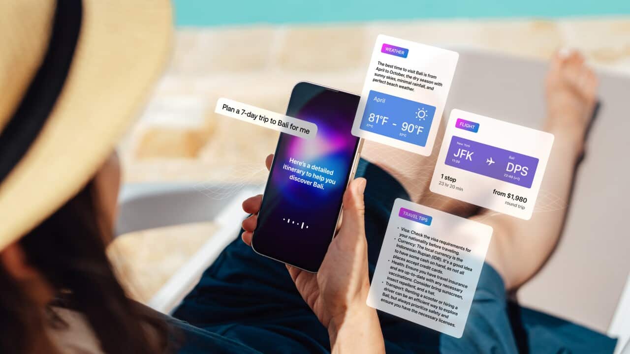 Over the shoulder view of young Asian woman using virtual assistance technology on smart phone to plan a trip