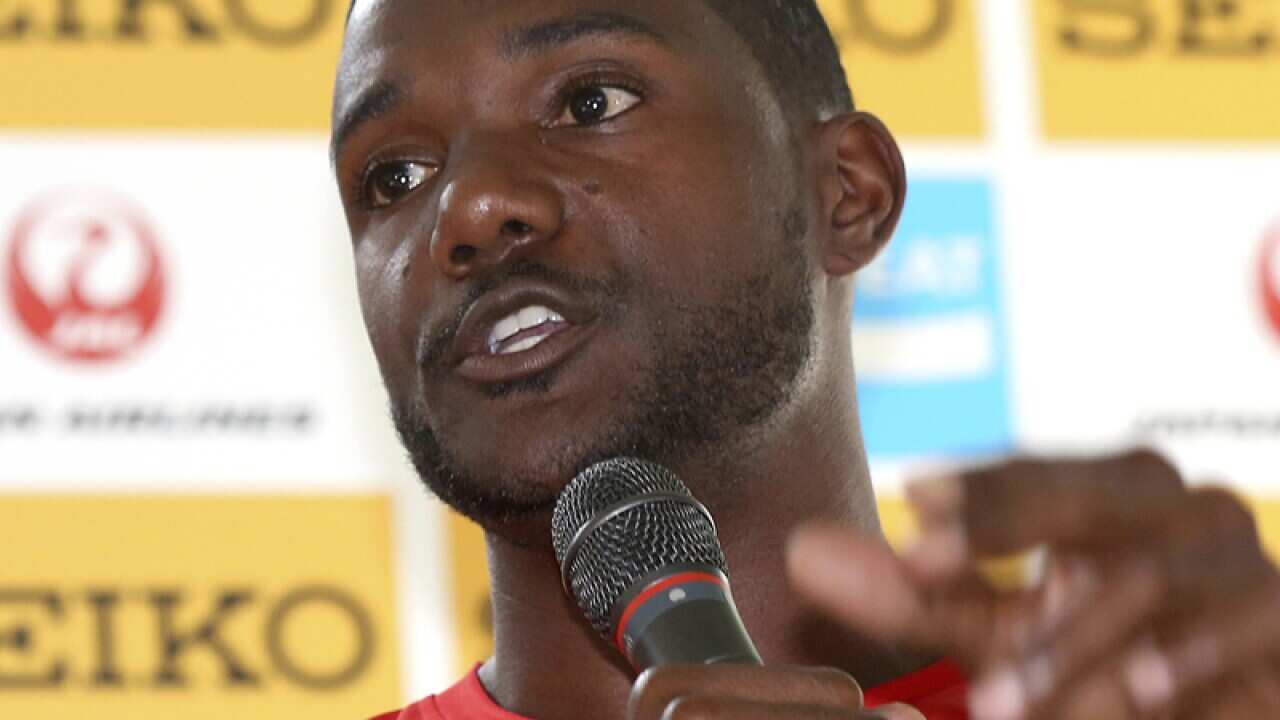 Justin Gatlin of the US answers questions from a journalist.