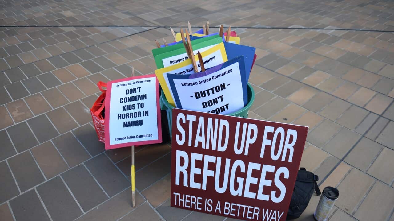 Asylum seeker advocate signs are seen after the High Court of Australia ruling on refugees to Nauru in Canberra, Wednesday, Feb. 3, 2016. 