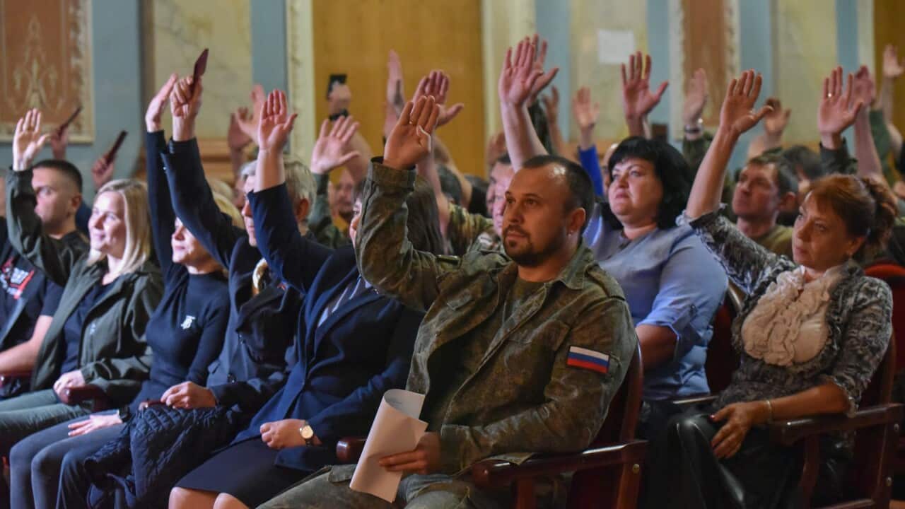 Council members attend a meeting with Denis Pushilin, Head of the Donetsk People's Republic, and raise hands to approve a referendum on the accession to Russia.