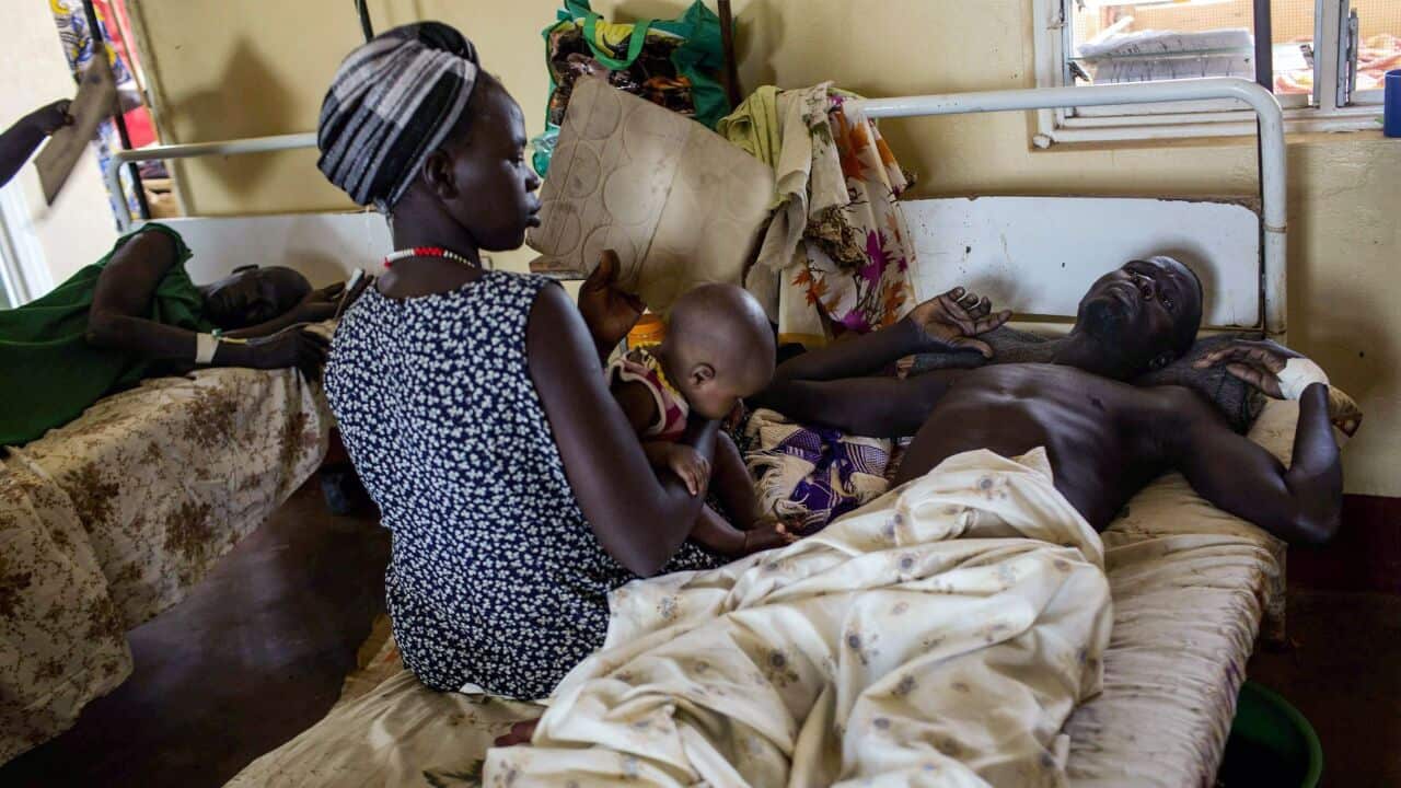 An injured South Sudanese soldier is visited in hospital by his family - AAP-1.jpg