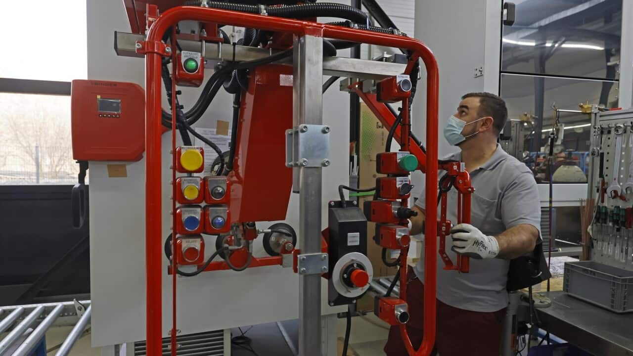 An employee works on an ultra-deep freezer required to store the COVID-19 vaccine (AAP)