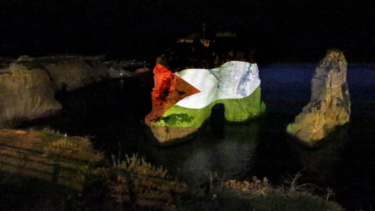 An illuminated photograph of Palestinian flag is projected onto the wall of the landmark Raouche sea rock in Beirut, Lebanon.