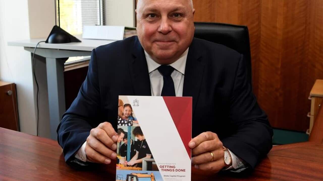 Victorian Treasurer Tim Pallas holds the the 2018/19 Victorian budget.
