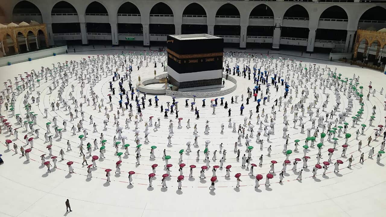 Hundreds of Muslim pilgrims observe social distancing at the Kaaba at the Grand Mosque in Mecca (AAP)