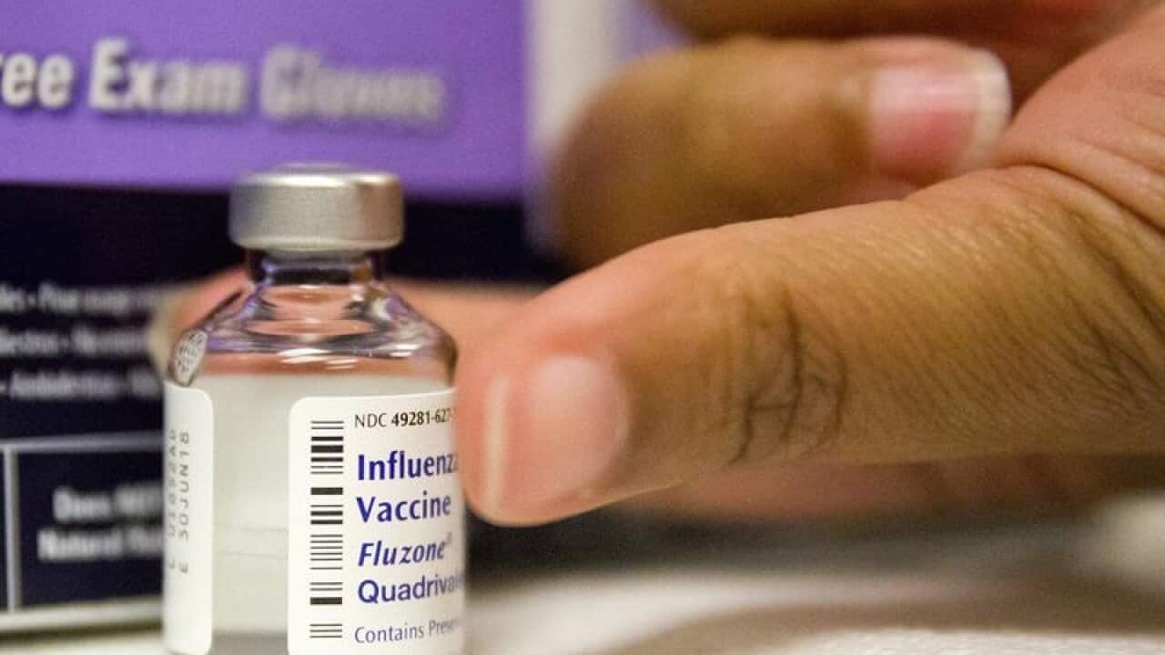 a nurse prepares a flu shot
