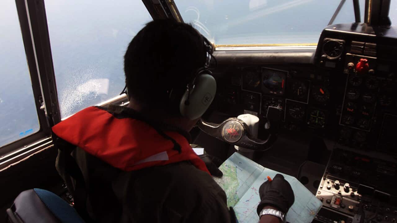 An Indonesian Navy pilot conducts an aerial search
