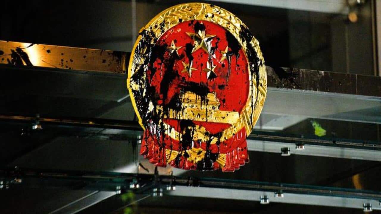 The national emblem at China's Liaison Office in Hong Kong is sprayed with black liquid