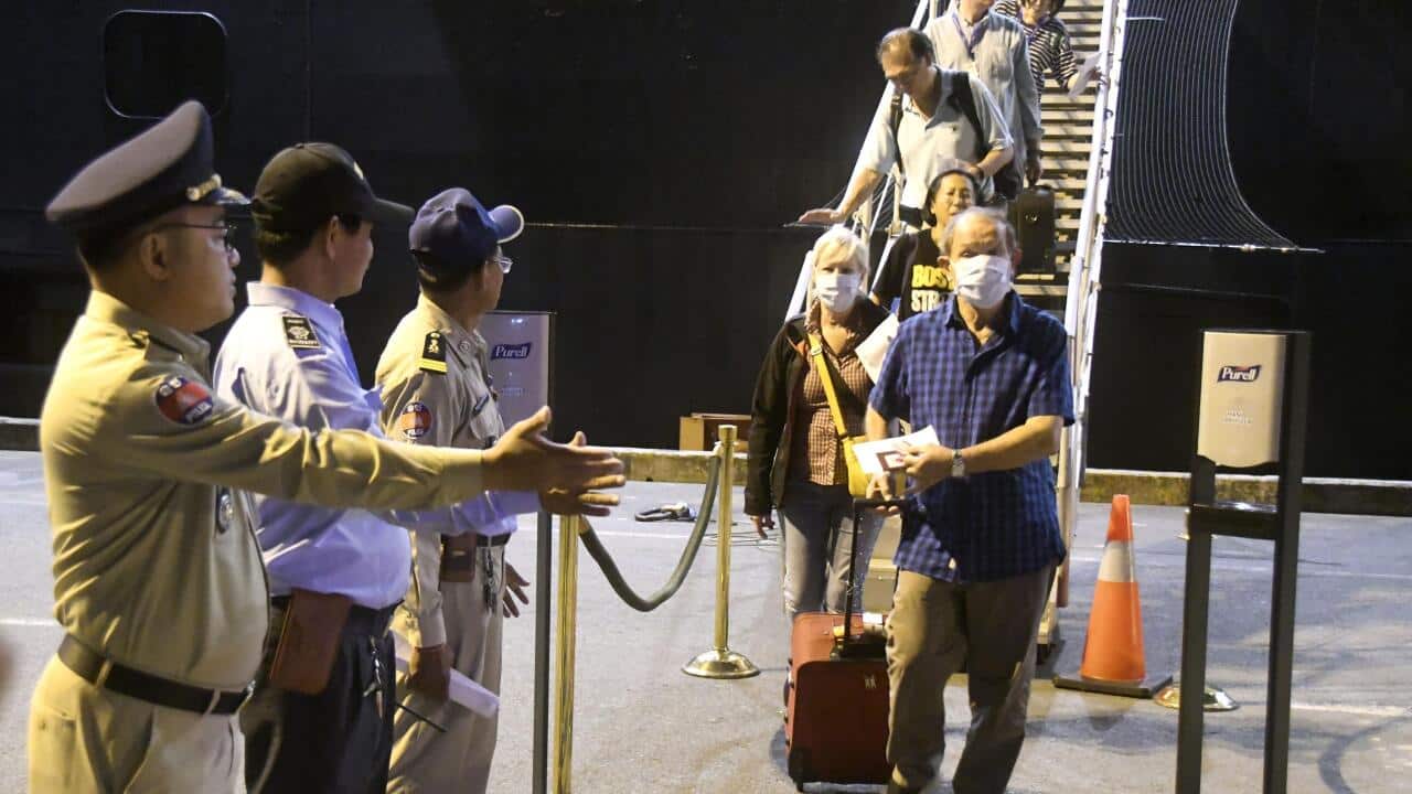 Passengers disembark from the Westerdam cruise ship at the port of Sihanoukville in Cambodia.