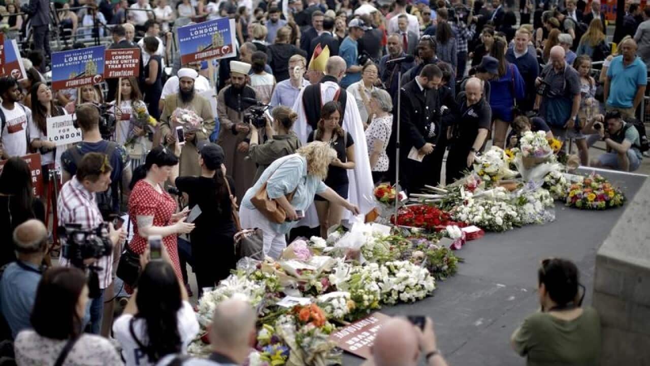 A file image of people laying flowers for the terror attack victims