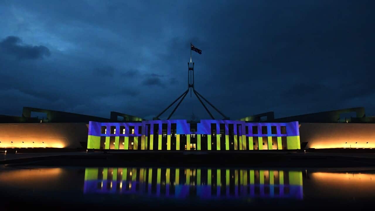 Australia’s Parliament House is illuminated with the colours of Ukraine’s flag in solidarity with the country's people and government, in Canberra, Monday, February 28, 2022. (AAP Image/Mick Tsikas) NO ARCHIVING