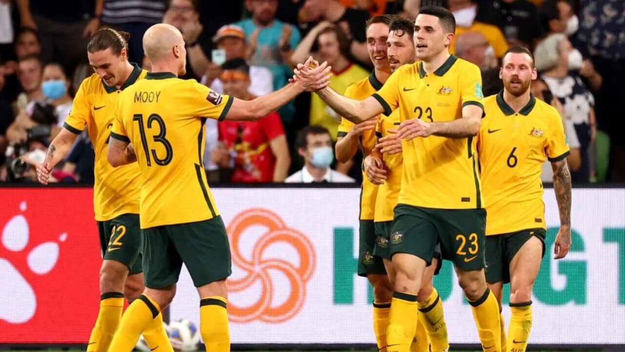 Tom Rogic celebrates a goal with his Socceroos teammates