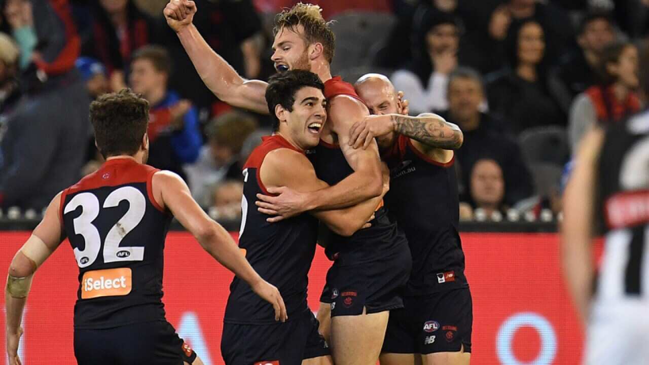 Demons players react after Jack Watts kicked a goal