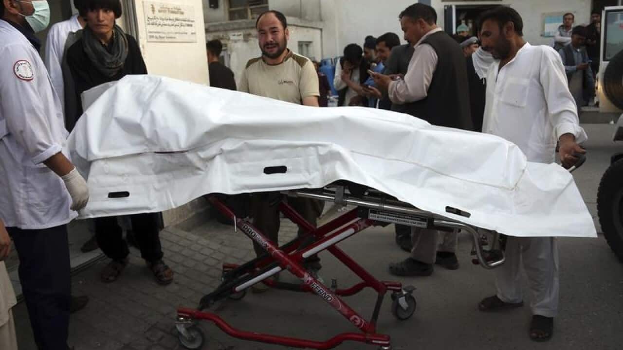 Afghans carry the body of a man who was killed in Kabul