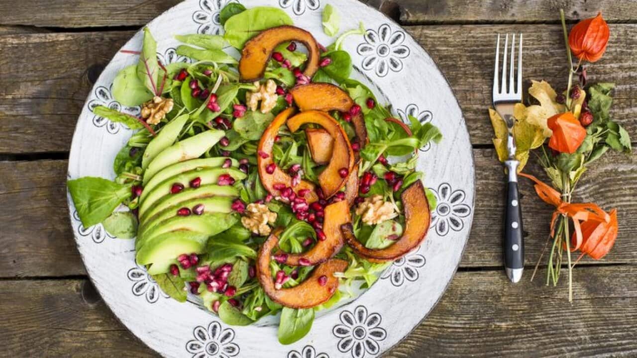 Autumnal salad with squash, pomegranate seeds, avocado and walnuts
