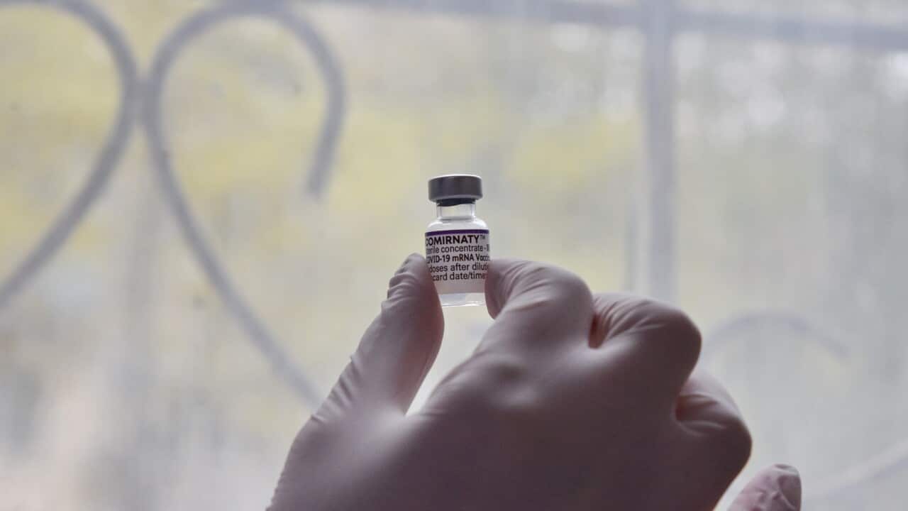 A health worker in Ukraine holds a vial containing Pfizer Covid-19 vaccine