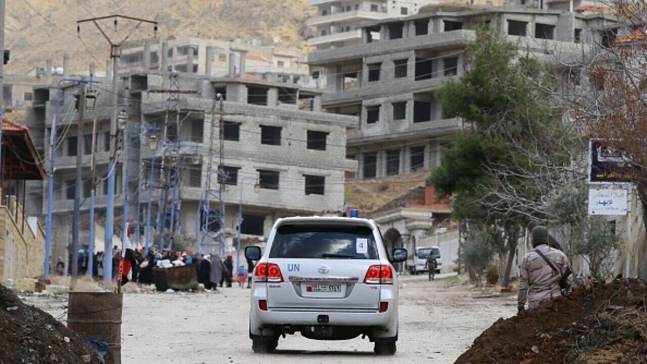 A UN vehicle enters the besieged rebel-held Syrian town of Madaya
