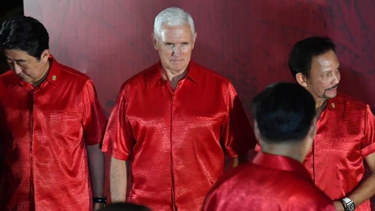 US VP Mike Pence looks at China's President Xi Jinping before the official photograph at APEC summit .