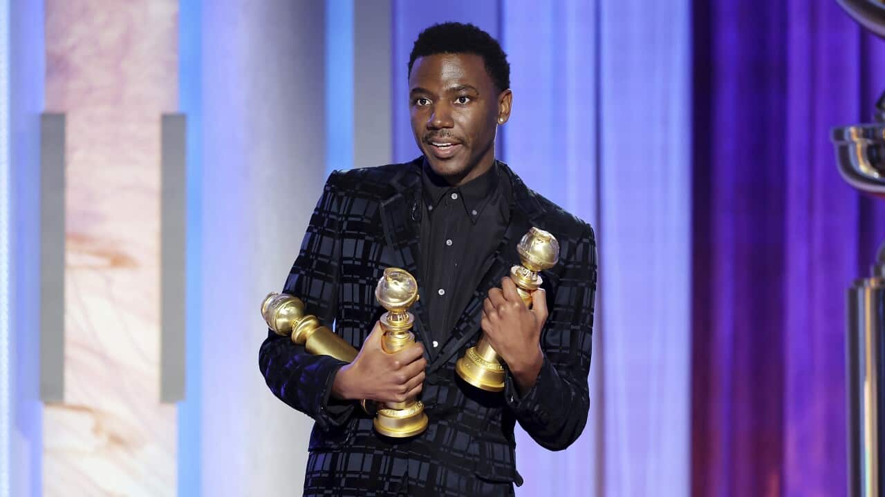 Man holding awards
