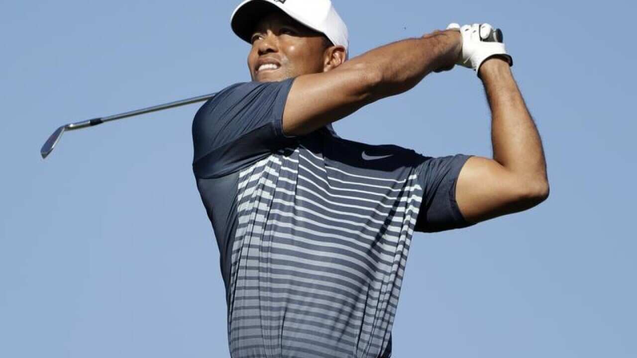 Tiger Woods watches his tee shot on the 15th hole.