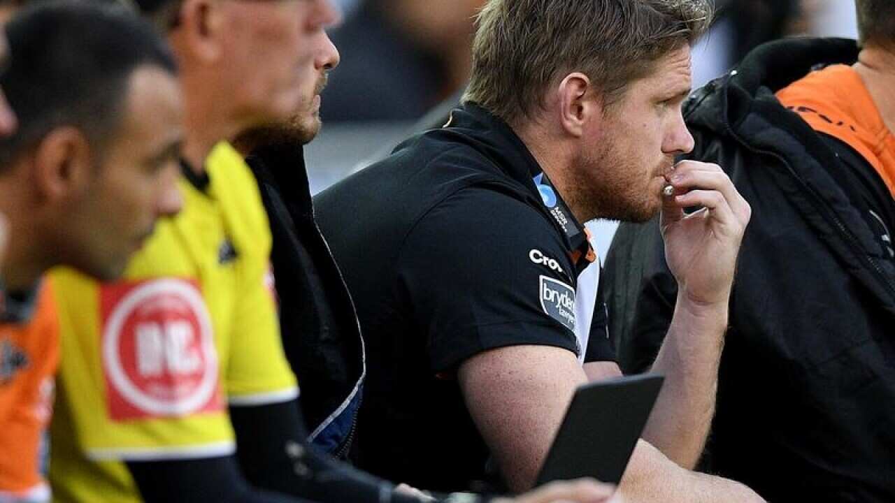 Chris Lawrence watches play from the Tigers' bench