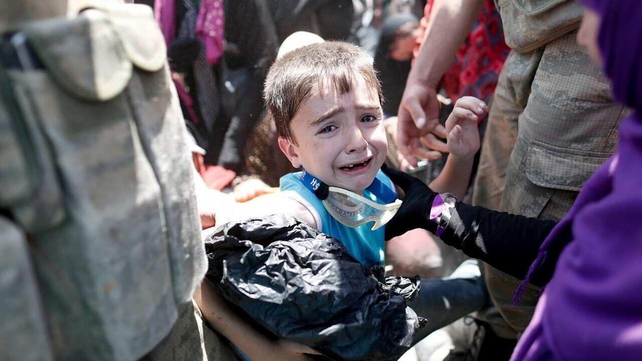 A Syrian refugee boy crossing into Turkey.