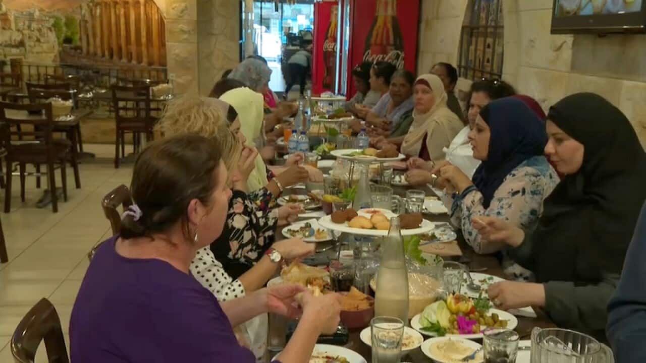 Families from Menindee and Belmore share a meal