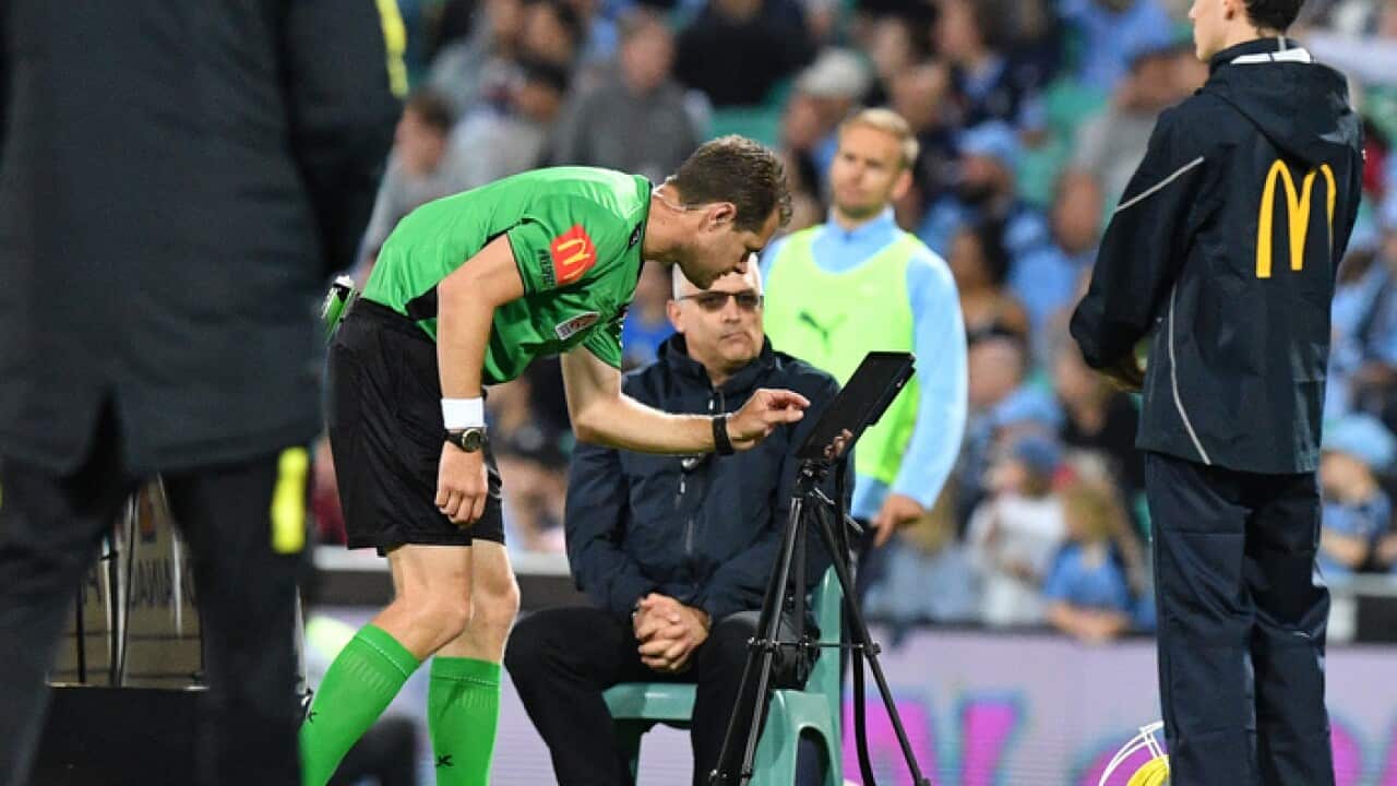 Referee Chris Beach examines the VAR during the Round 2 A-League match between Sydney FC and Western Sydney Wanderers at Sydney Cricket Ground in Sydney, Saturday, October 27, 2018. (AAP Image/Brendan Esposito) NO ARCHIVING, EDITORIAL USE ONLY