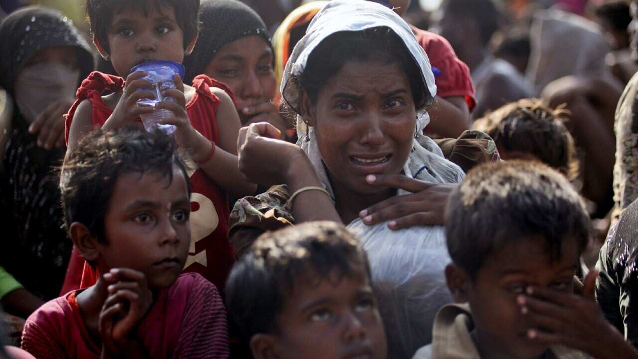 A rescued migrant weeps