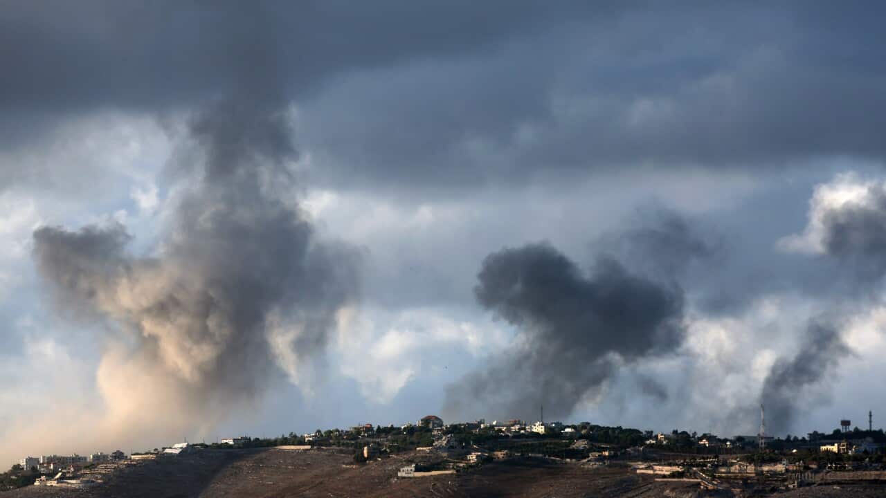 Smoke rises as a result of airstrikes near a village.
