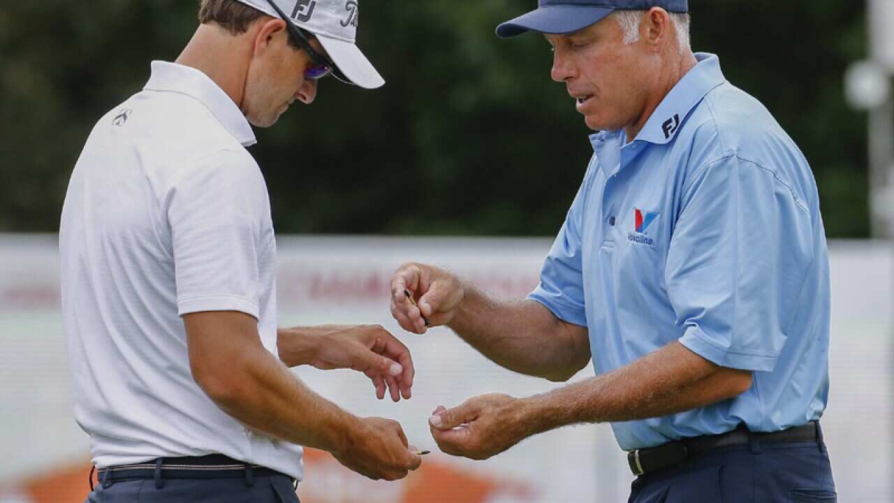 Adam Scott (L) of Australia and his caddie Steve Williams (R)