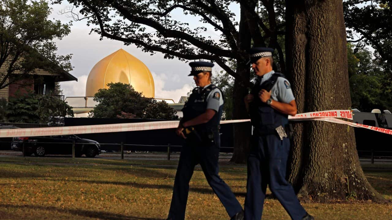 Police officers patrol at a park outside the Al Noor mosque in Christchurch