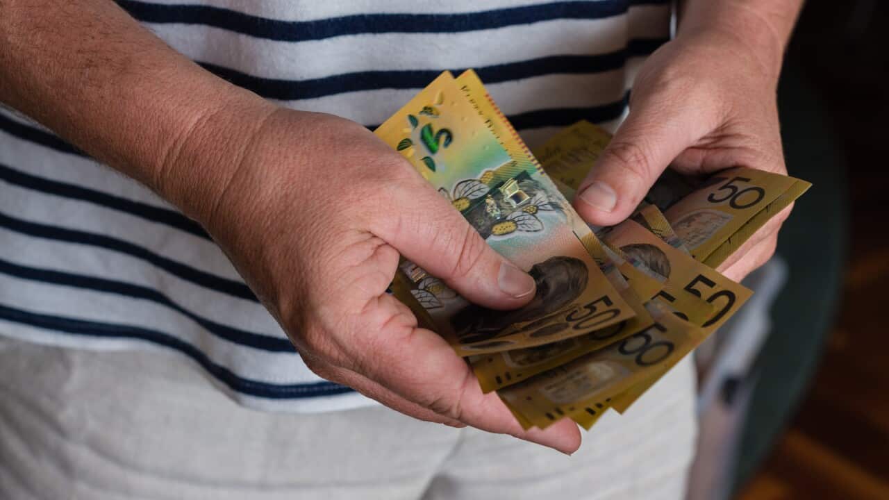 man counting Australian money