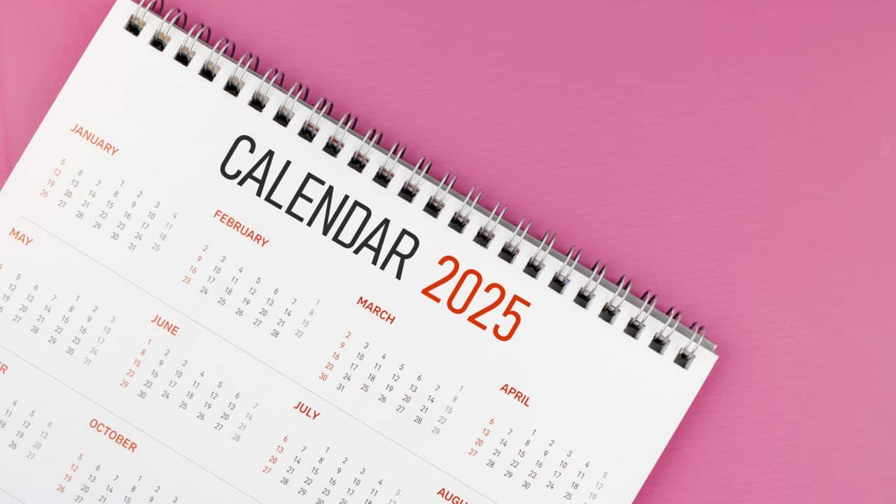 2025 desk calendar on pink color background, Position with copy space.