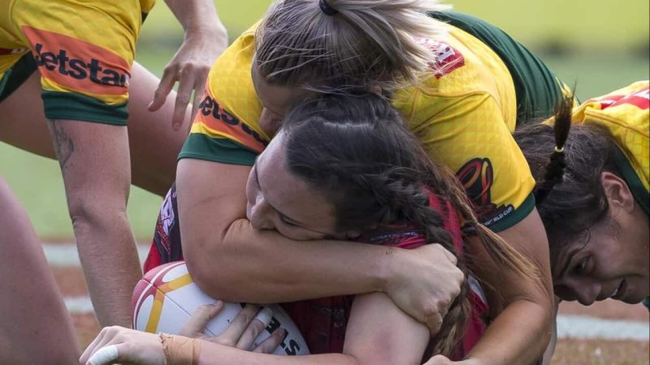 Renae Kunst of Australia tackles Janai Haupapa of Canada