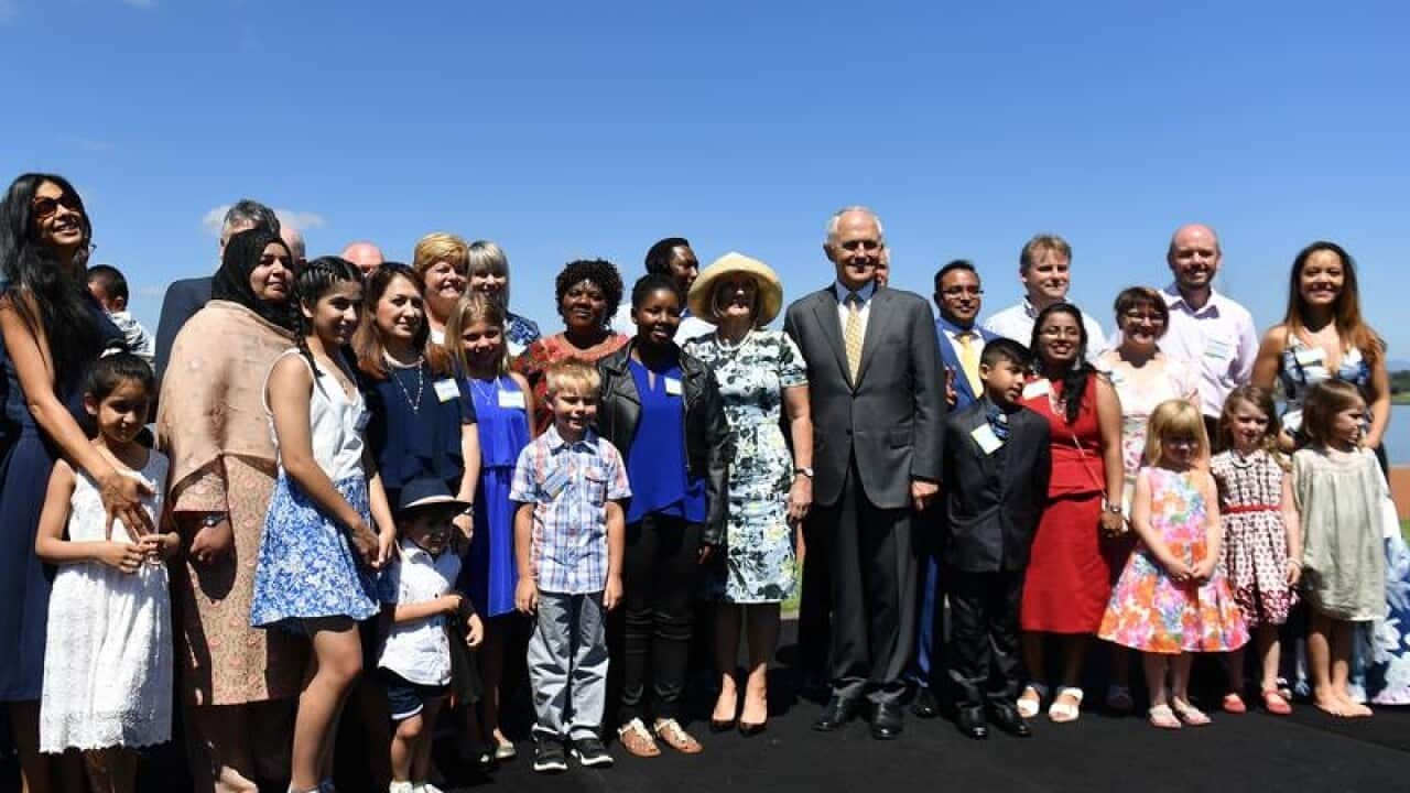 Prime Minister Malcolm Turnbull posing with new Australain citizens