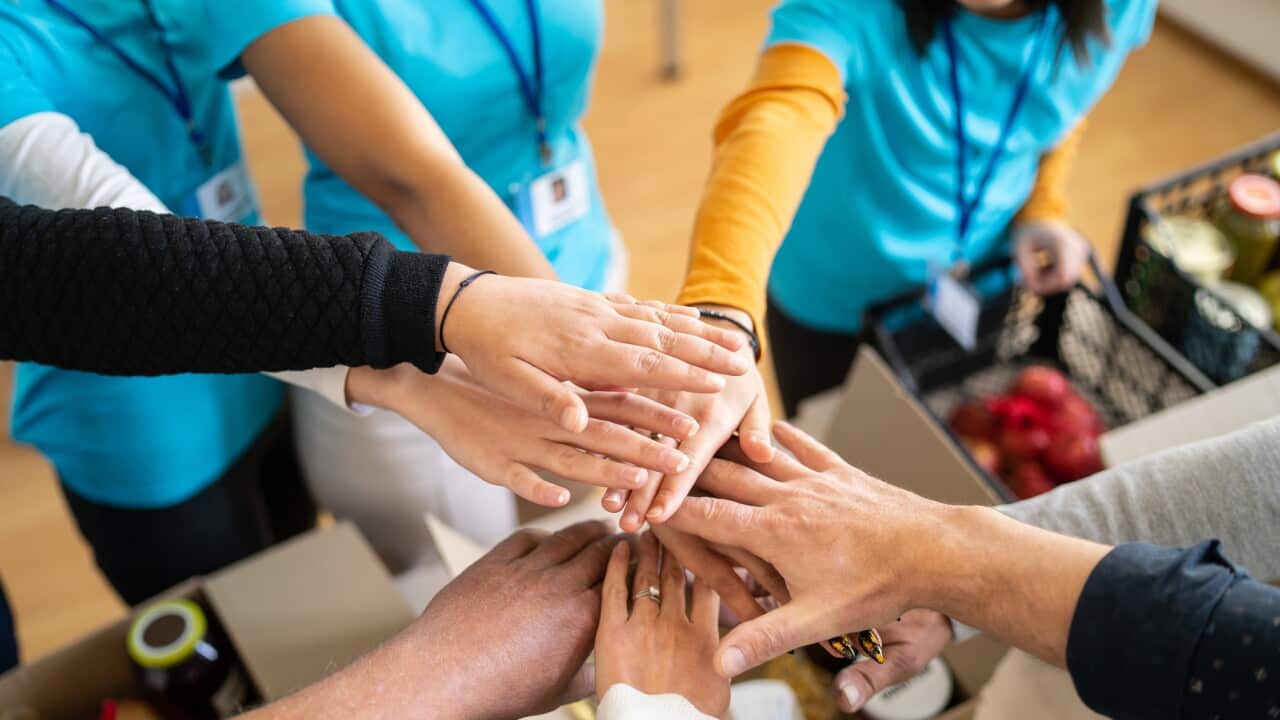 Volunteers hands stacking in a circle