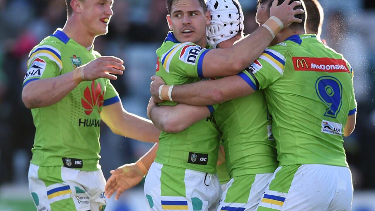 Canberra players celebrate after scoring a try