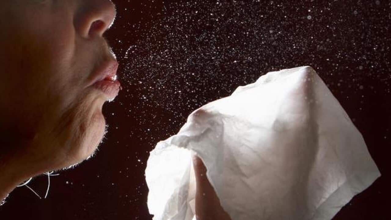 A woman sneezing