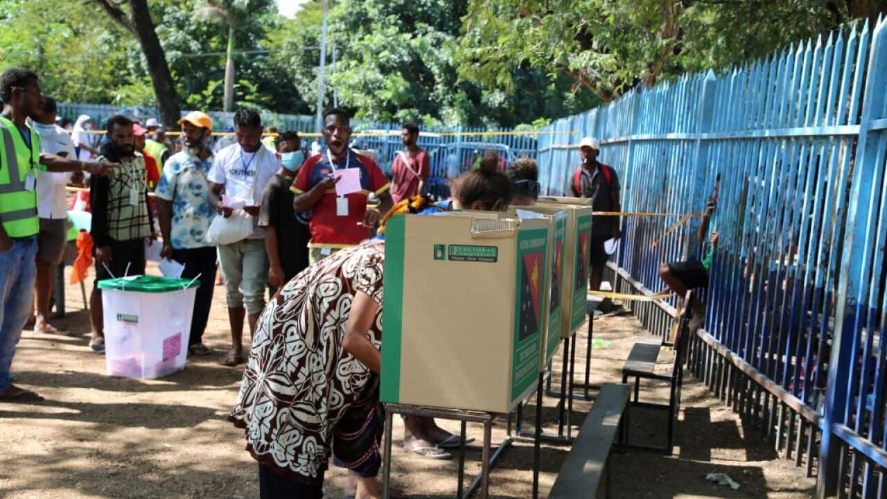 People lined up at voting booths in Port Moresby.