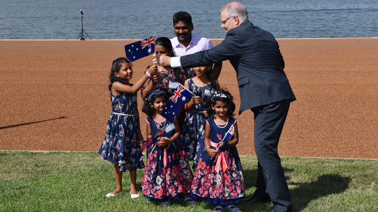 Prime Minister Scott Morrison hands out Australian flags to members of the Sebastien Family