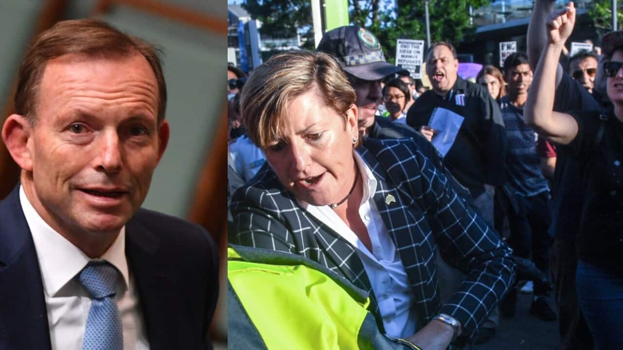 Christine Forster, Liberal councillor in the City of Sydney and sister of former prime minister Tony Abbott (L) is caught up in a crowd of protesters