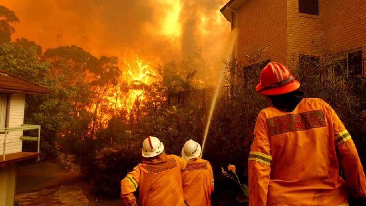 Fire fighters protect houses