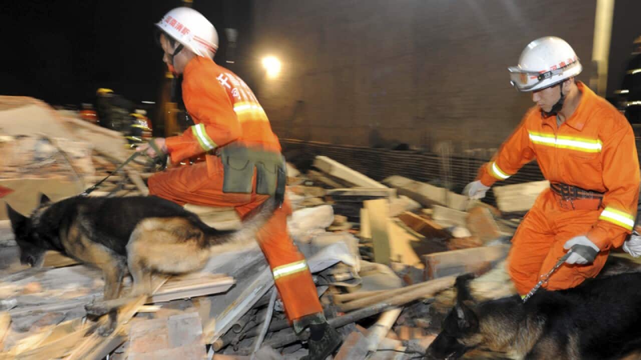 A two-story building collapsed into rubble.